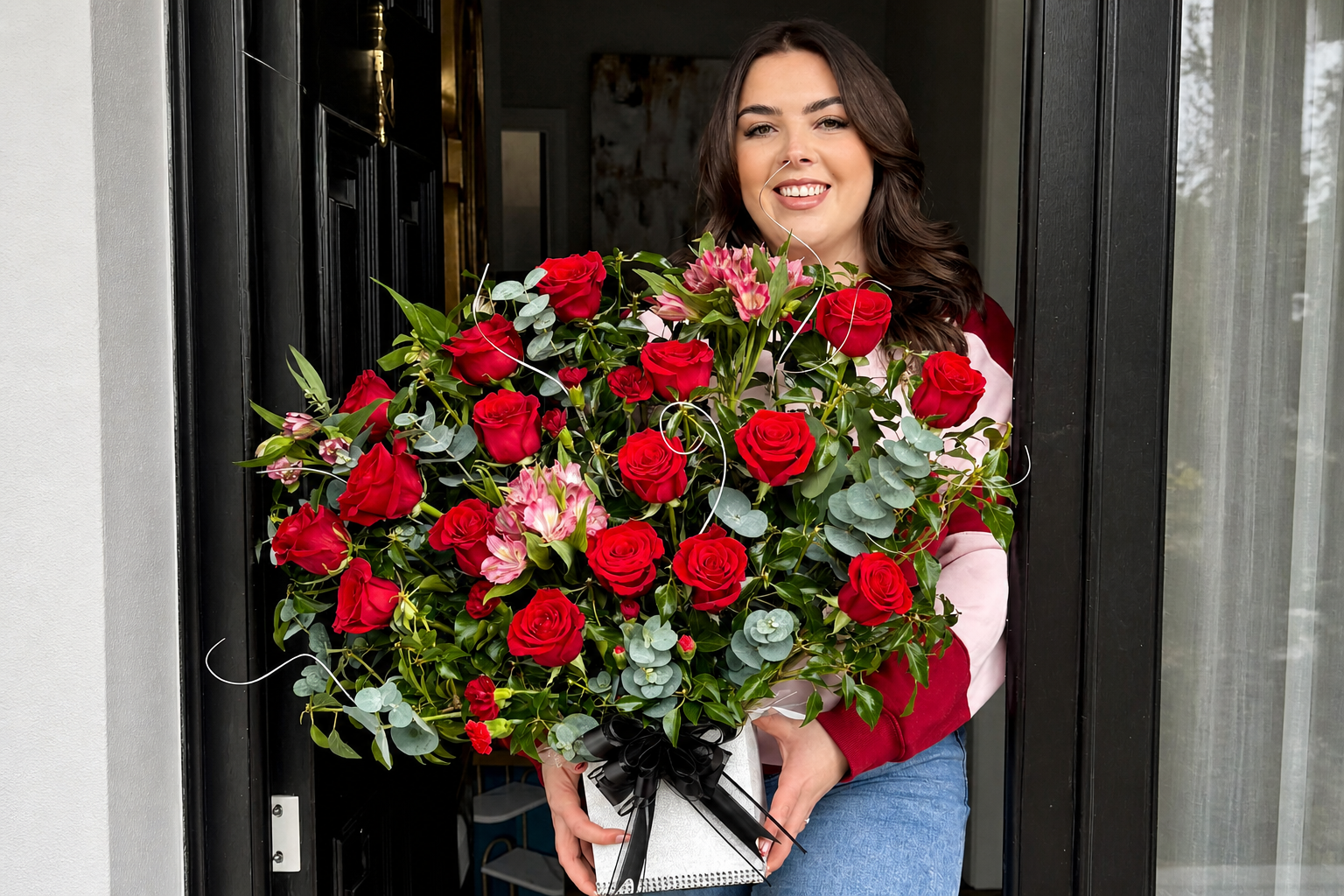 Woman holding red rose bouquet